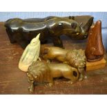 Various hardwood carved models of a rhino, two lions, carved horn model of a bird and one other