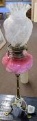 Victorian oil lamp, clear and etched glass shade over a pink glass font raised on a candlestick type