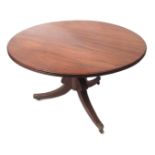 Regency period mahogany circular dining table, with reeded edge, raised on lobed baluster support