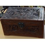 Oriental hardwood box, the lid, front and sides and back all carved with decorative panels enclosing