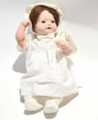 Large doll with baby clothes and bonnet