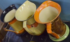 Pair of Myott & Sons Art Deco style jugs, one with a brown painted design, the other in orange and