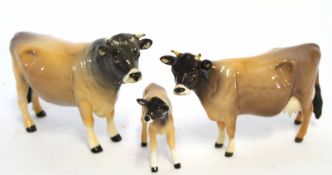 Group of three cattle designed by John Beswick, the bull marked Champion Onsley Coyboy, the cow