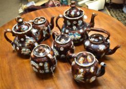 Collection of seven various barge ware tea pots, all typically decorated in the Majolica manner,