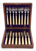 Early 20th century oak cased set of six each fish knives and forks each with polished blades and