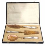 Continental cased three piece serving set, each with cast and applied handles to a gilt finished and
