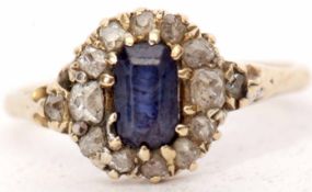 Antique sapphire and diamond cluster ring with a central rectangular shaped sapphire, within an