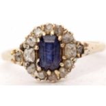 Antique sapphire and diamond cluster ring with a central rectangular shaped sapphire, within an