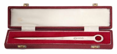 Elizabeth II cased letter opener of plain and polished skewer form with ring suspension, length