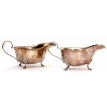 Two Elizabeth II sauce boats of typical polished form with cut card rims, strapwork handles and