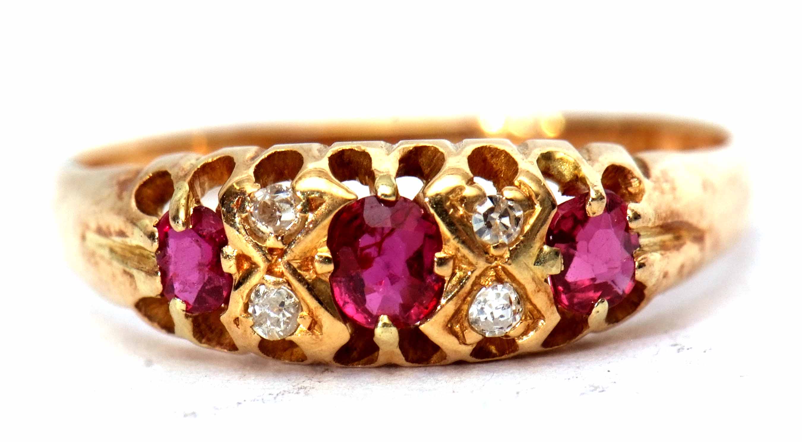 18ct gold ruby and diamond ring featuring 3 oval shaped rubies interspersed with 4 small diamonds,