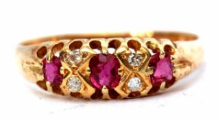 18ct gold ruby and diamond ring featuring 3 oval shaped rubies interspersed with 4 small diamonds,