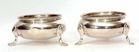 Two Victorian cauldron salts, each of polished form with beaded rims on three cast and applied feet,