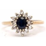 Modern 9ct gold, sapphire and diamond cluster ring, the oval faceted shaped sapphire raised within a