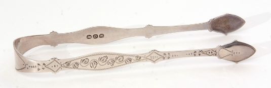 Pair of late George III sugar tongs of shaped and engraved form with vacant cartouche to the bridge,