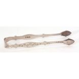 Pair of late George III sugar tongs of shaped and engraved form with vacant cartouche to the bridge,