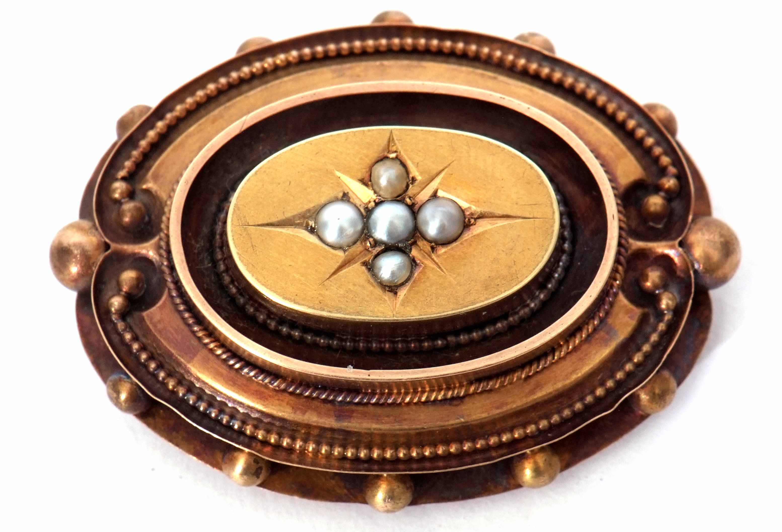 Victorian mourning brooch, the centre engraved with a star setting, set with five grey pearls, verso