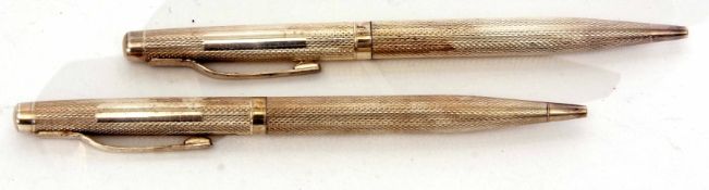 Two Elizabeth II silver cased propelling pencils, each of tapering cylindrical form with all over