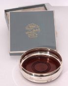 Elizabeth II silver and mahogany bottle coaster, the plain polished surround to a ring turned inset,
