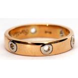 A 750 stamped two-tone ring, a plain polished design featuring six pierced hexagonal shaped holes,