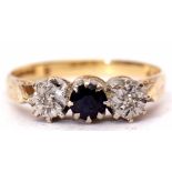 18ct gold diamond and sapphire three stone ring, the central circular shaped sapphire flanked by two