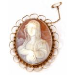 An oval carved shell cameo depicting a head and shoulder profile of a lady, framed in an ornate