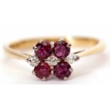 18ct ruby and diamond cluster ring featuring three small diamonds between four circular cut