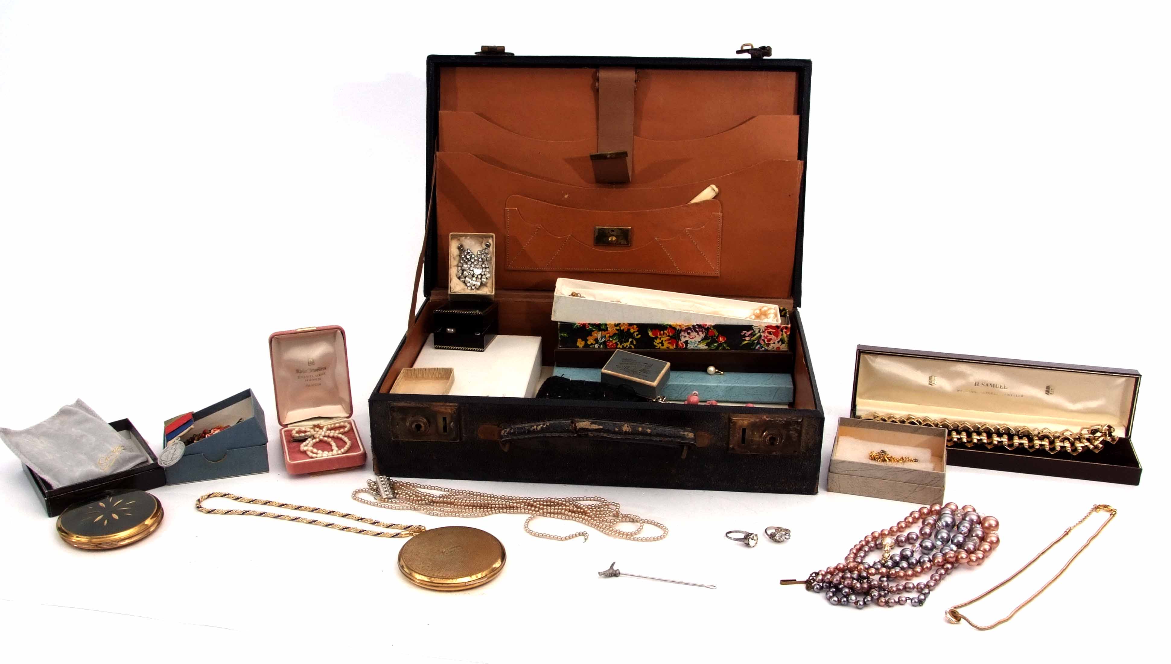 Blue leatherette suitcase to include various costume jewellery comprising necklaces, simulated