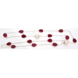 Modern white metal necklace set with sculptured rubies and baroque pearls, all framed and