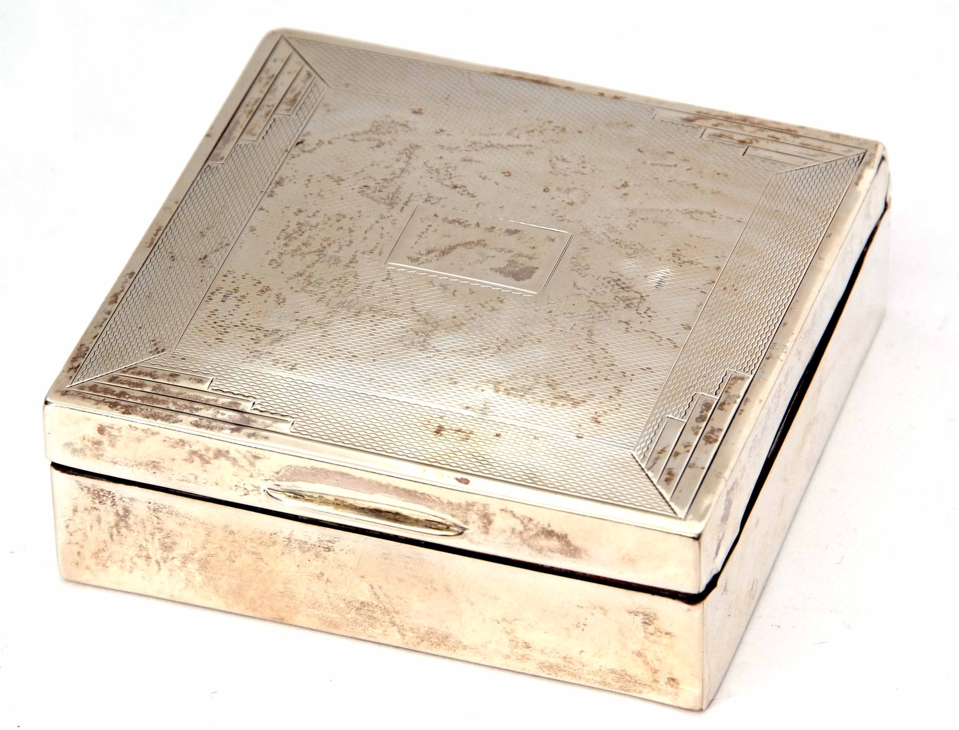 George V table cigarette box of square form, the hinged cover with engine turned decoration and