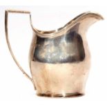 George V helmet shaped milk jug, the plain and polished body with applied reeded rim and handle,