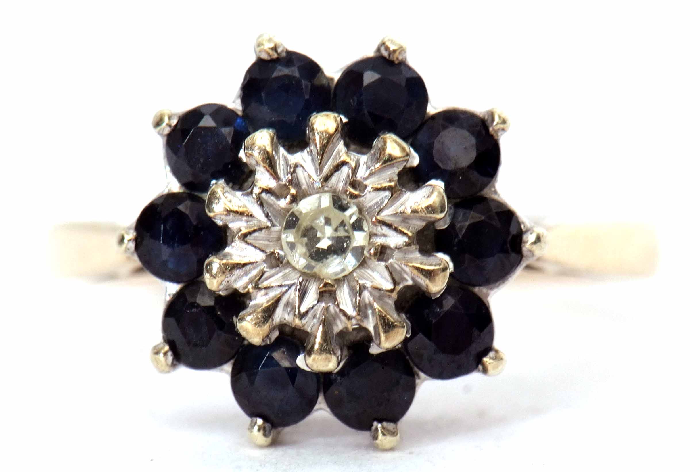 9ct gold, sapphire and diamond cluster ring, the small central diamond claw set in an illusion