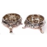 Two mid-Victorian cauldron salts, each with embossed floral and foliate bodies on three cast and