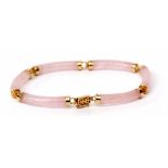 Modern yellow metal and pink jade articulated bracelet, the six cylindrical jade links each capped