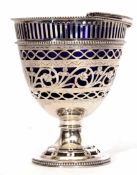 Unmarked white metal table sugar basket in the form of a footed pail with hinged handle, pierced and