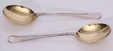 Two George V Arts & Crafts style serving spoons, stylised coffin end handles with double struck