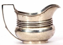 Edward VII milk jug of ribbed oval baluster form with applied handle, width 14cm, weight approx