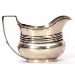 Edward VII milk jug of ribbed oval baluster form with applied handle, width 14cm, weight approx