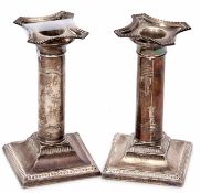 Matched pair of early 20th century candlesticks (one a/f), on plain columsn on sprading square bases