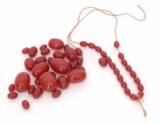 A cherry amber broken bead necklace of graduated size, 1cm - 3cm, 74gms gross weight