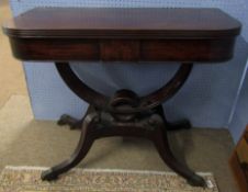 Regency period mahogany tea table, the folding and swivelling top raised on curved supports