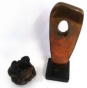 Copper metal abstract sculpture on square black wooden base, together with a further carved wooden