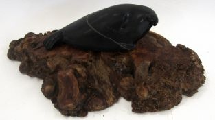 Stone Eskimo art sculpture of a whale, together with a root carving, the carving 38cm long