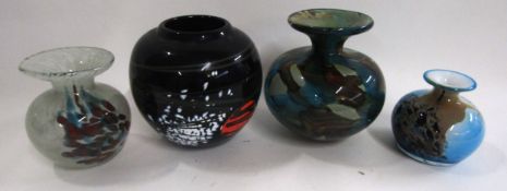 Group of four glass baluster vases all with multi-coloured mottled designs, one with a Mdina