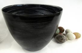 Large Art Glass bowl containing a collection of onyx paperweights, the bowl 30cm diam