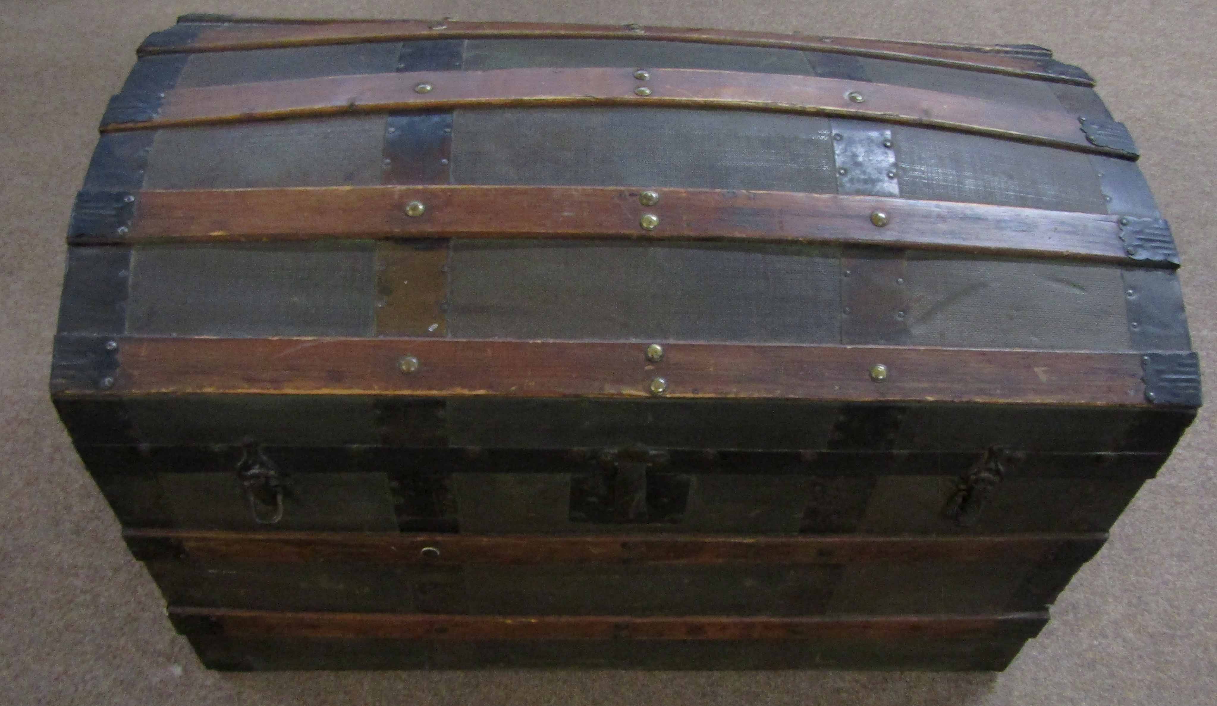 Early 20th century pine banded domed top trunk with metal strapwork and mounts, 87cm long