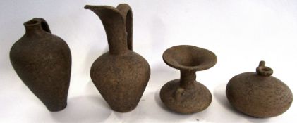 Group of Middle Eastern style pottery wares comprising three ewers and a small vase with lug