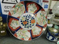 19TH CENTURY IMARI CHARGER TYPICALLY DECORATED WITH BLUES, REDS AND FLORAL PANELS
