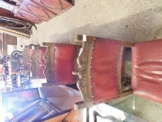 SET OF FOUR OAK FRAMED DINING CHAIRS WITH RED LEATHER UPHOLSTERED SEATS AND BACK, CARVED FRONT LEGS