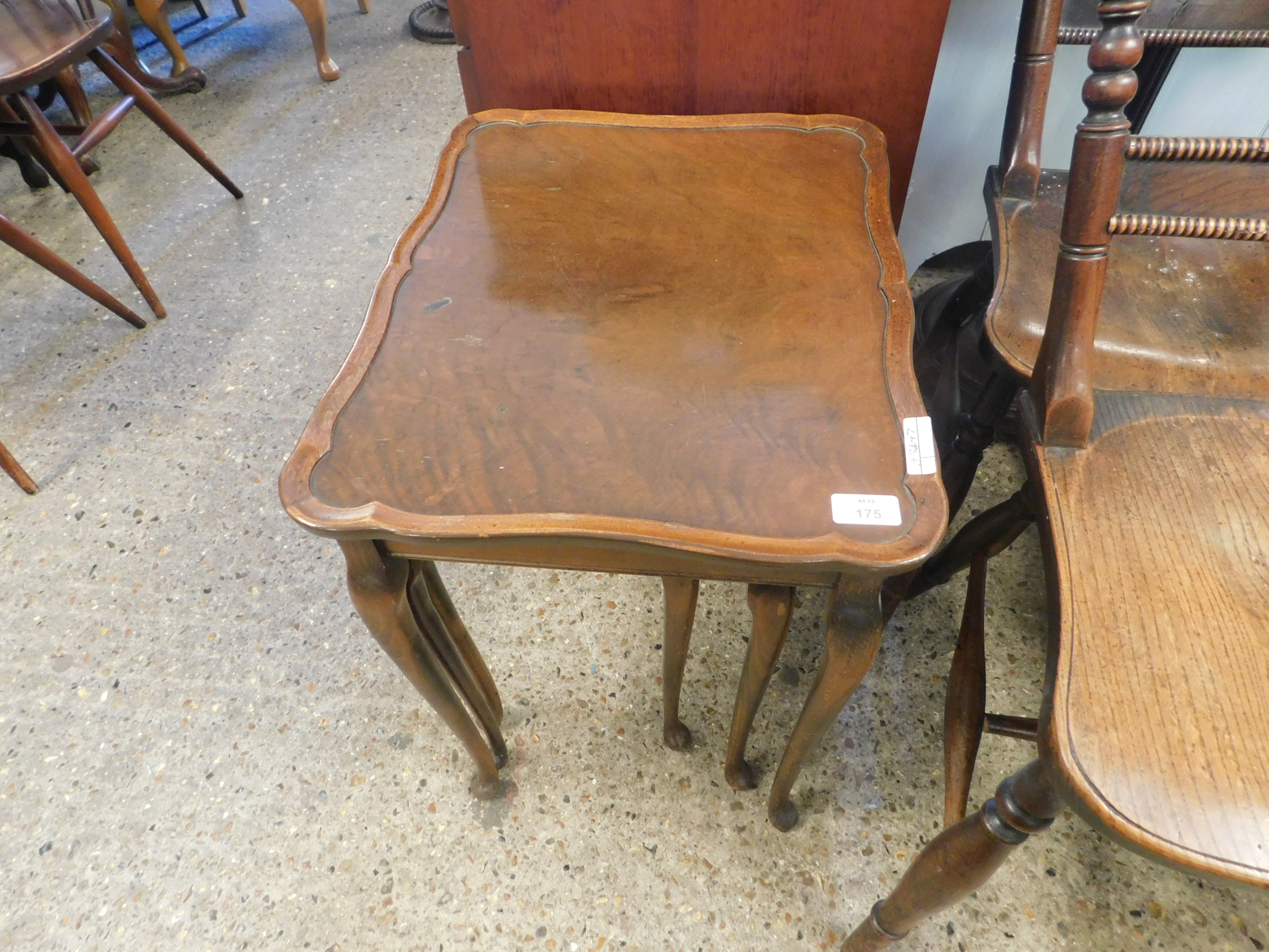 MID-20TH CENTURY WALNUT NEST OF THREE TABLES WITH SHAPED TOPS